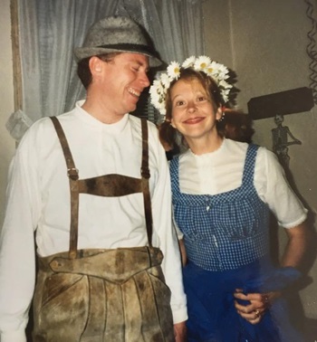 two people smiling in costumes